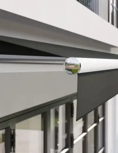 Toldo brazo extensible sin cofre instalado en fachada de vivienda en Ibiza con protección solar para terraza.